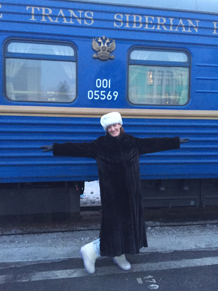 A woman in front of a Trans-Siberian train