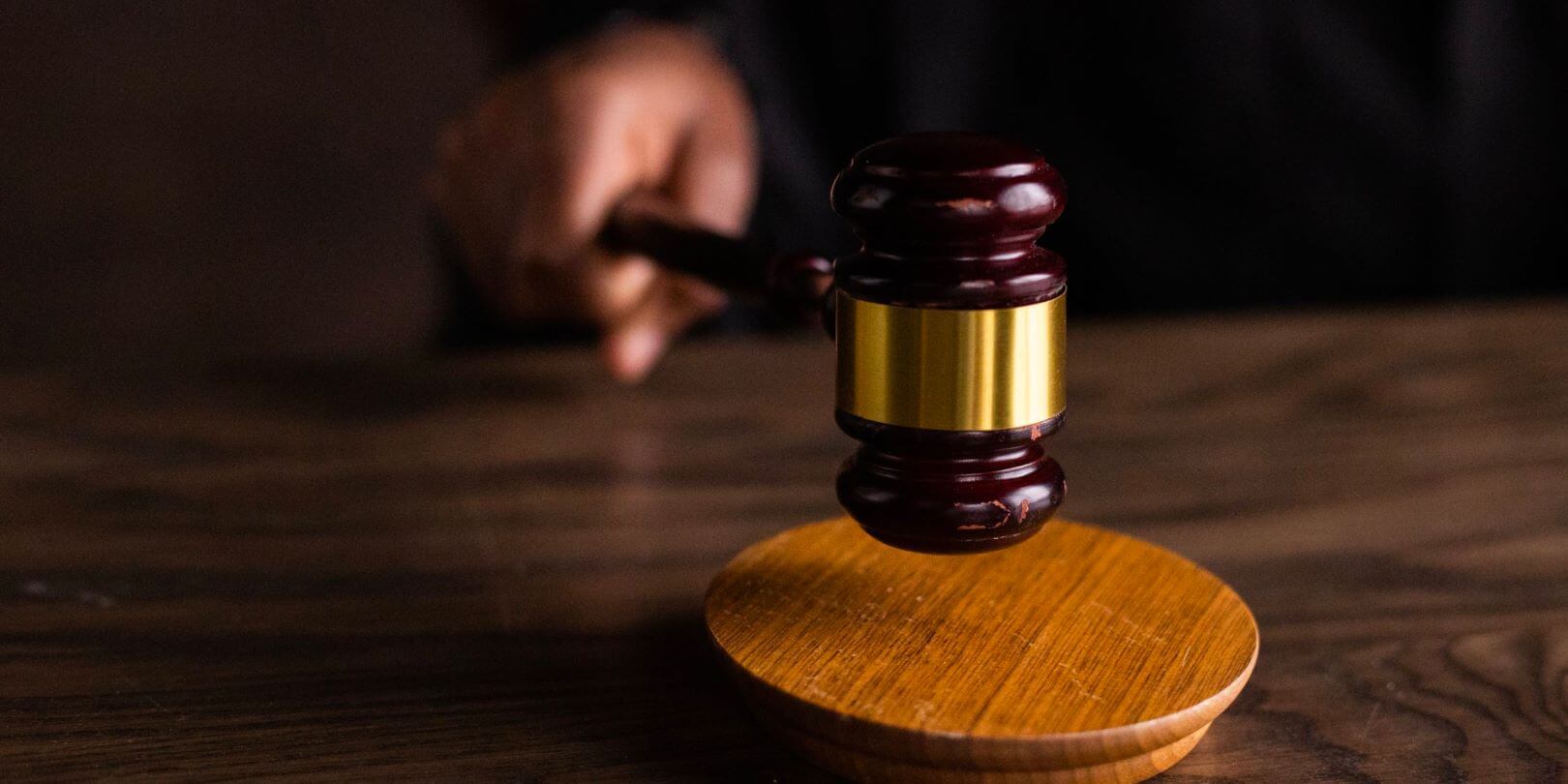 closeup shot of a hand holding a gavel