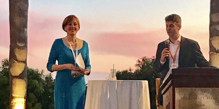 a man and woman on the stage are speaking